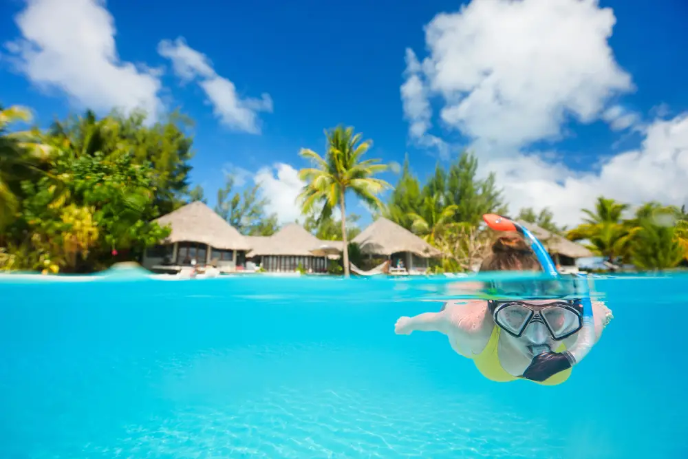 Woman snorkeling next to the island in the water things to do before we die