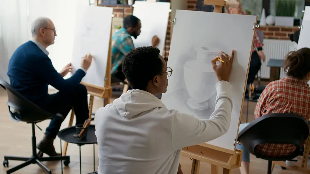 African american student using pencil to draw vase model on canvas in art class. Young man drawing sketch masterpiece at lesson with teacher to develop educational growth. Artwork design things to do before you die self development goal