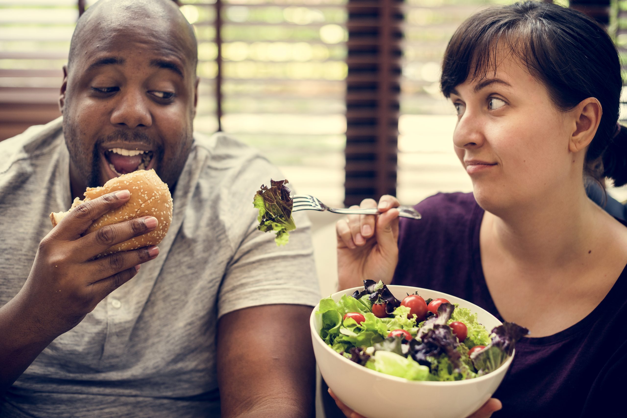 Couple having fast food on the couch